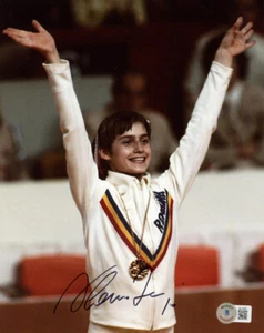 NADIA COMANECI SIGNED 8x10 PHOTO + 10 OLYMPIC GYMNASTICS LEGEND ICON BECKETT BAS - Picture 1 of 2