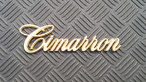 OEM GOLD Cadillac Cimarron Body/Dash Emblem. LARGE script - Picture 1 of 1