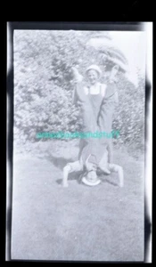 black and white negative - 2 men in overalls horsing around handstand on lawn - Picture 1 of 3