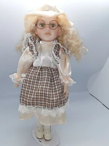 Porcelain doll with checkered dress, glasses and hat - Picture 1 of 7