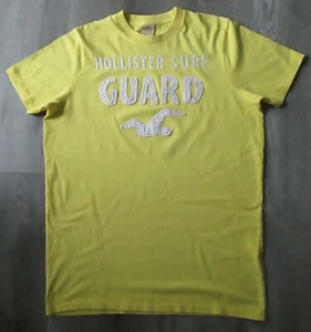 T-SHIRT VINTAGE HOLLISTER SURF GUARD STITCH SPELLOUT GRAFICA GIALLA DA UOMO TAGLIA L - Foto 1 di 2