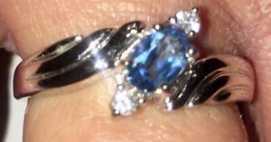 Blue Topaz Sterling Silver Rhodium Plated Ring With CZ Side Stones