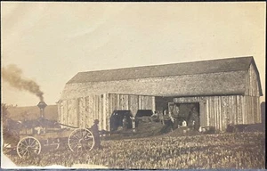 RPPC REAL PHOTO POSTCARD-FARMING~MEN AT WORK HAYING BARN STEAM POWERED ENGINE - Picture 1 of 3