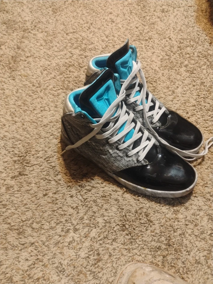 pair of Nike Kobe 9 NSW Lifestyle sneakers in the black and platinum colorway. - Image 1 of 4