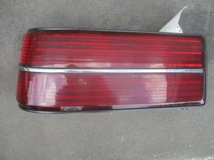 85-88 Grand Am LH Tail Lamp w/Chrome Ctr Trim - Picture 1 of 4