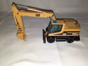 NZG Caterpillar CAT M318 cuchara baja - móvil - excavadora escala 1:50 - Imagen 1 de 9