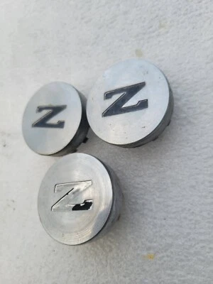 ✅️ Factory 1984 to 1989 Nissan 300ZX alloy wheel center caps hubcaps 40343 03P00 - Image 1 of 4