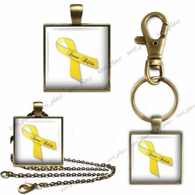 Cinta Amarilla Espina Bífida Conciencia 1" Vidrio Top Llavero Colgante o Collar Foto 1 de 4