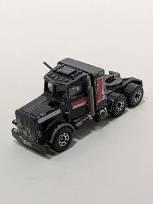 ATTRACTIVE & BOLD BLACK/RED 1981 PETERBILT TRACTOR CAB 1:64 SCALE BY MATCHBOX  - Image 1 of 4