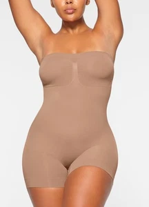 SKIMS NEU OHNE ETIKETT NAHTLOS GEFORMTER TRÄGERLOSER SHORTIE-BODY GRÖSSE S FARBE TON - Bild 1 von 4