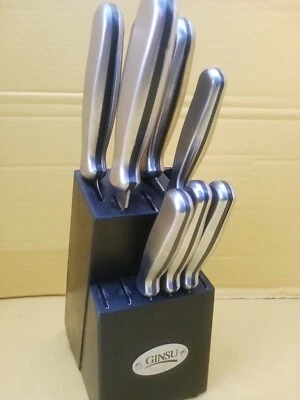 Juego de 8 cuchillos de acero inoxidable dentados de mango pesado Ginsu plateados con soporte Foto 1 de 4