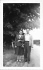 2 vintage photos men women woman holding camera car road