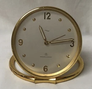 RELOJ DESPERTADOR PLEGABLE IMHOF VINTAGE TONO DORADO REDONDO MEDIADOS DE SIGLO 8 DÍAS 15 JOYAS - Imagen 1 de 20