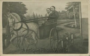 Two young women in fake horse carriage antique studio rppc photo - Picture 1 of 1