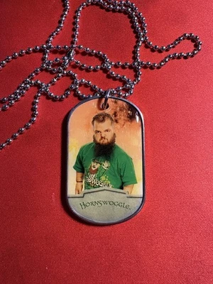 2012 Topps WWE Ringside Relic Dog Tags Hornswoggle green shirt relic  - Image 1 of 2