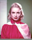 Janet Leigh wearing a high-neck red satin blouse with a white flor- Old Photo