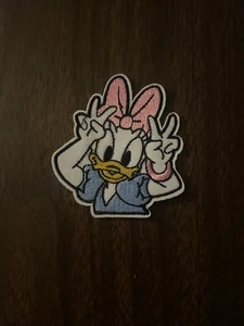 Daisy Duck Giving A Peace Sign Embroidered Iron On Patch 3x2.75 Inch - Picture 1 of 3
