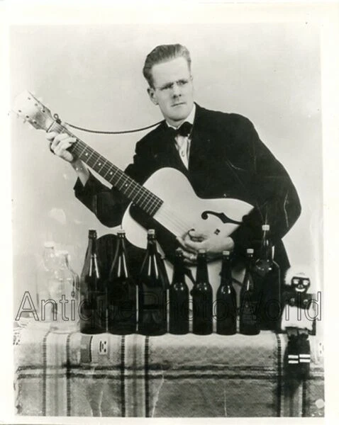 Man musician w guitar bottles and doll comedian vintage music photo - Image 1 of 1