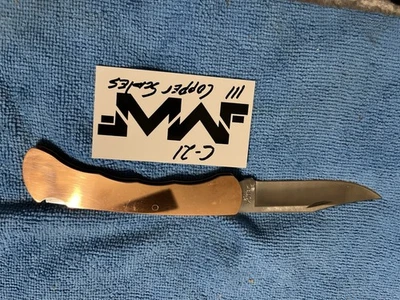 Básculas de cobre pulido personalizadas Buck 110, ranura para dedos Foto 1 de 4