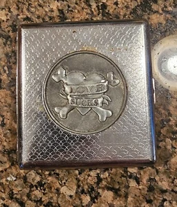 Nulite Cigarette Case Hinged Metal "Love Sucks" Heart Cross Bones Square Vntg - Picture 1 of 5