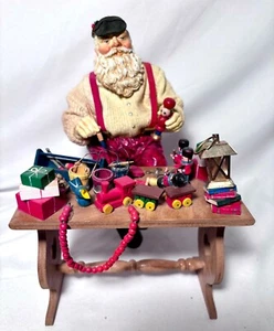 WEIHNACHTSMANN SITZT AUF BANK MALEREI SPIELZEUG MITTLERER WESTEN VON KANONE FÄLLT STOFFMACHE  - Bild 1 von 11