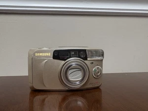 Samsung Evoca 140S Quartz Date Multi AF Filmkamera Gold 2000 Millenium Edition - Bild 1 von 5