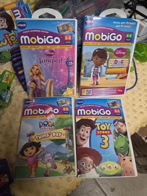 Lot of 4 MobiGo Games VTech Disney Toy Story 3 Disney Tangled Dora - Image 1 of 4