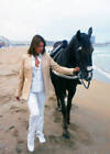 Mexican actress Jaqueline de la Vega walking a horse on the beach,- Old Photo
