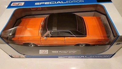 Pontiac GTO 1965 Maisto, escala 1:18 diecast, - NARANJA con tapa de vinilo negro Foto 1 de 4