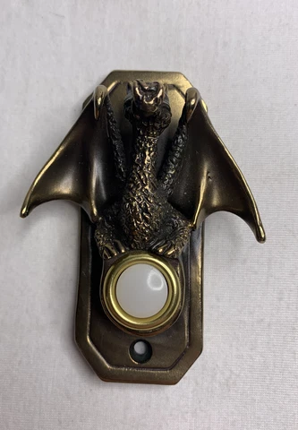 Butch Honeck Bronze Dragon  Door Bell Plate 26/100. Approximately 3 3/4”x 1 1/2” Cover