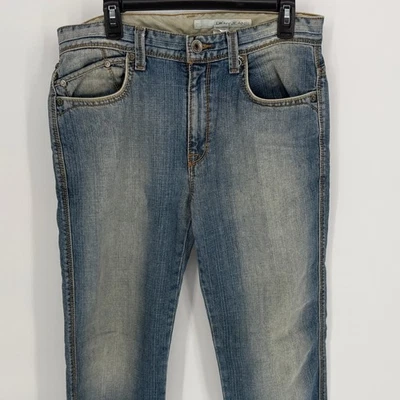 Pantalones de mezclilla DKNY para hombre 32x32 lavado claro calce relajado diseñador bolsillos con solapa Foto 1 de 4