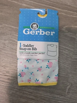 Babero de vinilo vintage Gerber para niños pequeños a presión con bolsillo para atrapar migas flores rosas Foto 1 de 3