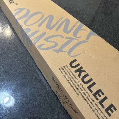 NEW Donner DCF-100G  Ukulele Carbon Fiber + Strap Tuner Strings Picks New Orange - Image 1 of 4