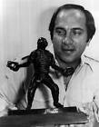 Cincinnati Reds star catcher Johnny Bench admires the bronze sculp- Old Photo