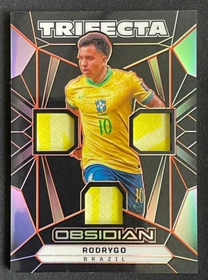 Rodrygo 2024-25 Panini Obsidian Trifecta Materials E/E Orange 97/99 #TM-R - Image 1 of 2