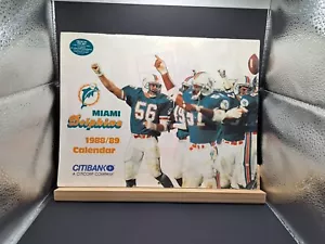 1988/1989 MIAMI DOLPHINS WALL CALENDER-DAN MARINO/MARK CLAYTON/SHULA/JOHN MADDEN - Picture 1 of 3