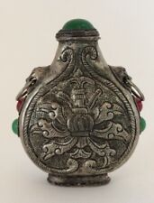 TIBETAN SILVER SNUFF BOTTLE. INSET WITH GREEN AND RED STONES. 
