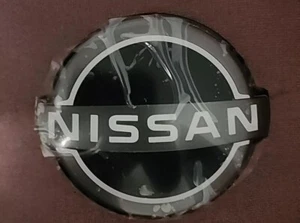 NISSAN ROGUE 2021 2022 2023 FRONT GRILLE EMBLEM - NEW STYLE OUTLINE 62890-6RM0A - Picture 1 of 3