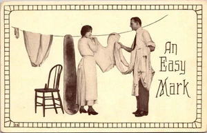An Easy Mark Man Woman Couple Doing Laundry Clothesline Ironing Board Postcard - Picture 1 of 2