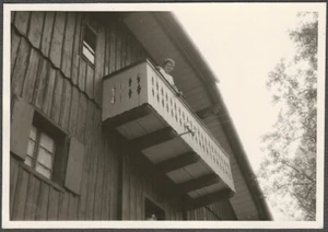 Woman Looks Down from Painted Wood Balcony of European House Original Snapshot - Picture 1 of 1