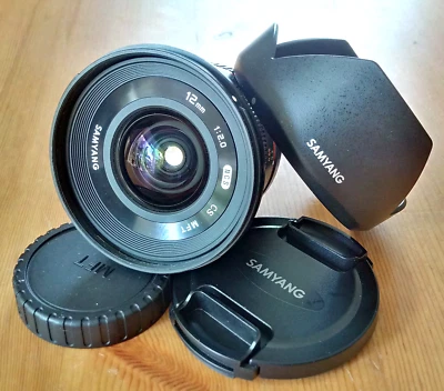Samyang 12mm f/2 NCS CS Ultra Wide Manual Focus Camera Lens for MFT + Hood, Caps - Image 1 of 4