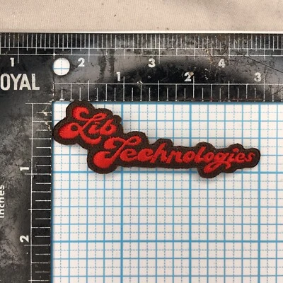 VINTAGE LIB TECH SNOWBOARDS ADVERTISING BROWN RED 3" CURSIVE IRON ON CLOTH PATCH - Image 1 of 2