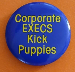 CORPORATE EXECS KICK PUPPIES - 1980's Popular anti-corporate slogan button - Picture 1 of 1