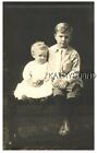 REAL PHOTO POSTCARD D+3158 BOY WITH BOOK IN HAND SITS NEXT TO HIS LITTLE BROTHER