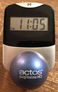 Actos Pharmaceutical Drug Rep Clock Alarm Date Balances On Ball - Picture 1 of 9