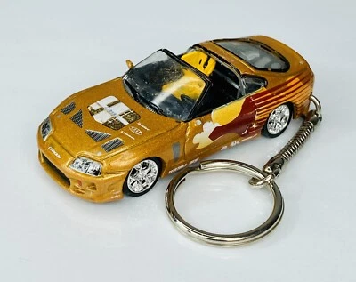 Racing Champions 2 Fast 2 Furious Gold 1995 Toyota Supra 1:64 Keychain - Image 1 of 4
