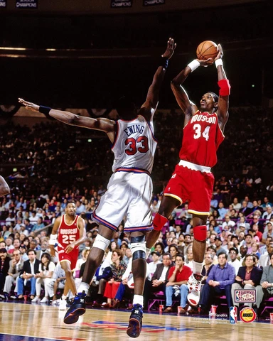 Hakeem Olajuwon Houston Rockets Unsigned Red Jersey Shooting 8" x 10" Photo Cover