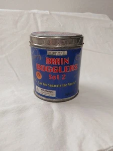 Brain Bogglers 2er Set Puzzle Metall Spielzeugschmied enthält 5 Puzzles mit Lösungen - Bild 1 von 3