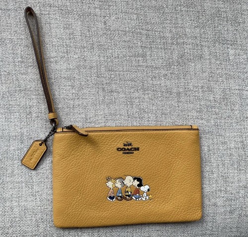 Coach Peanuts borsa da polso in pelle gialla Charlie marrone Snoopy & Gang usata in ottime condizioni!