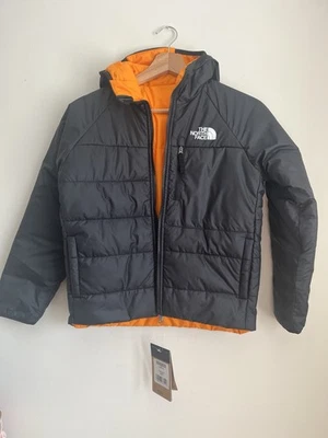 The North Face Boys' Reversible Perrito Jacket in black with an orange interior - Image 1 of 4